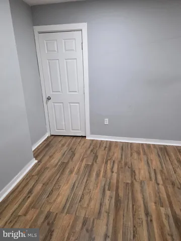 a view of room with wooden floor