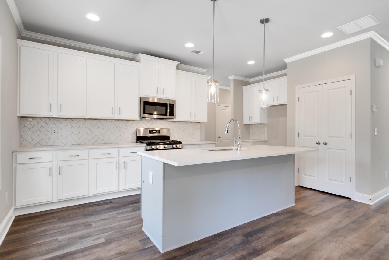 2059 Easterwood Court, Unit 2 Decatur, GA 30032 - Photo 1 of 1 a kitchen with kitchen island a sink stainless steel appliances and white cabinets