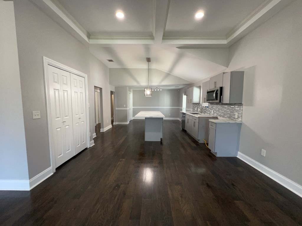 401 Walton Street Houston, TX 77009 - Photo 11 of 27 a kitchen with stainless steel appliances granite countertop a sink stove and wooden floor