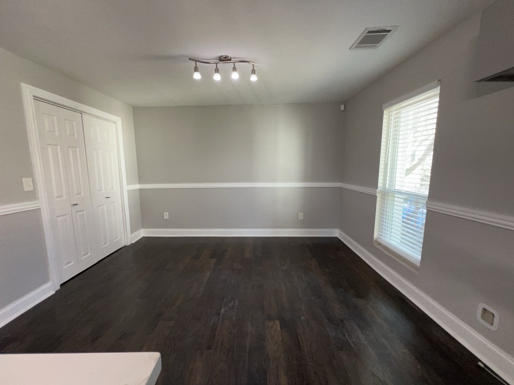 401 Walton Street Houston, TX 77009 - Photo 14 of 27 an empty room with wooden floor and windows