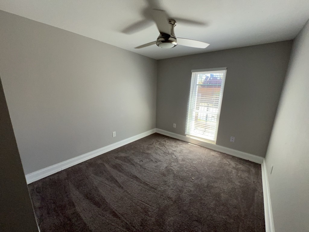 401 Walton Street Houston, TX 77009 - Photo 19 of 27 an empty room with a chandelier fan and windows