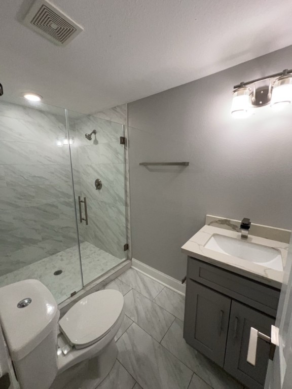 401 Walton Street Houston, TX 77009 - Photo 21 of 27 a bathroom with a granite countertop sink toilet a mirror and shower