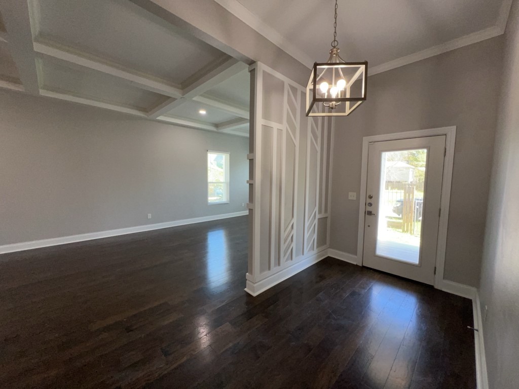 401 Walton Street Houston, TX 77009 - Photo 4 of 27 an empty room with wooden floor chandelier and windows