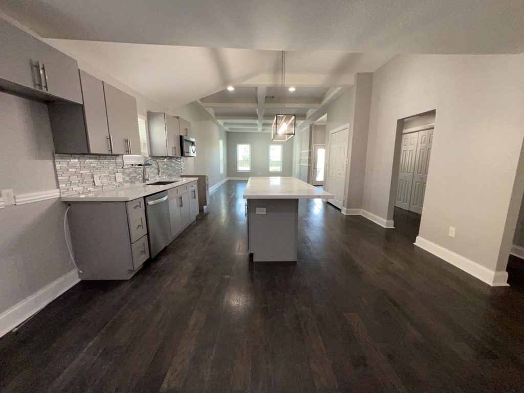 401 Walton Street Houston, TX 77009 - Photo 9 of 27 a large kitchen with stainless steel appliances a lot of counter space and wooden floor