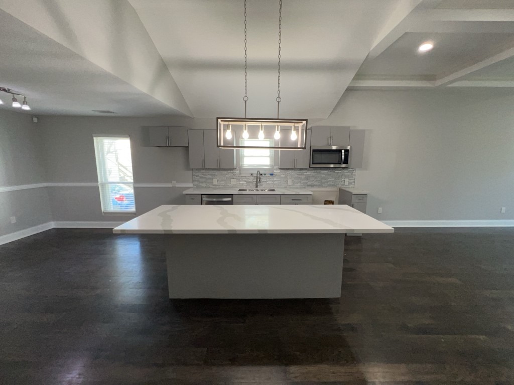 401 Walton Street Houston, TX 77009 - Photo 10 of 27 a kitchen with a sink cabinets and wooden floor