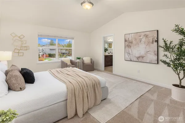 a bedroom with a large bed and a window