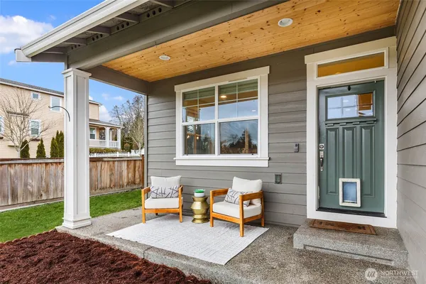 a backyard of a house with barbeque oven table and chairs