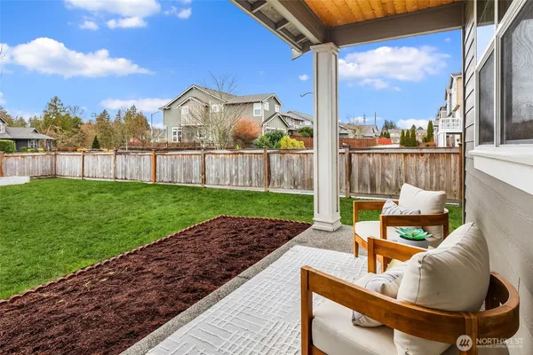 a view of a patio with a table chairs and a fire pit