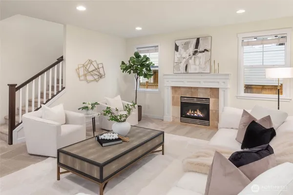 a living room with furniture a rug and a fireplace