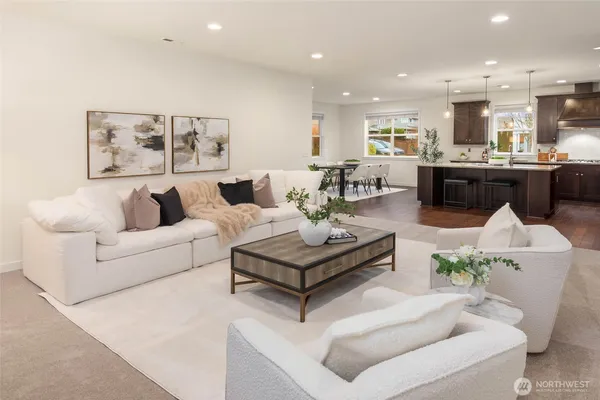 a living room with furniture and a view of kitchen