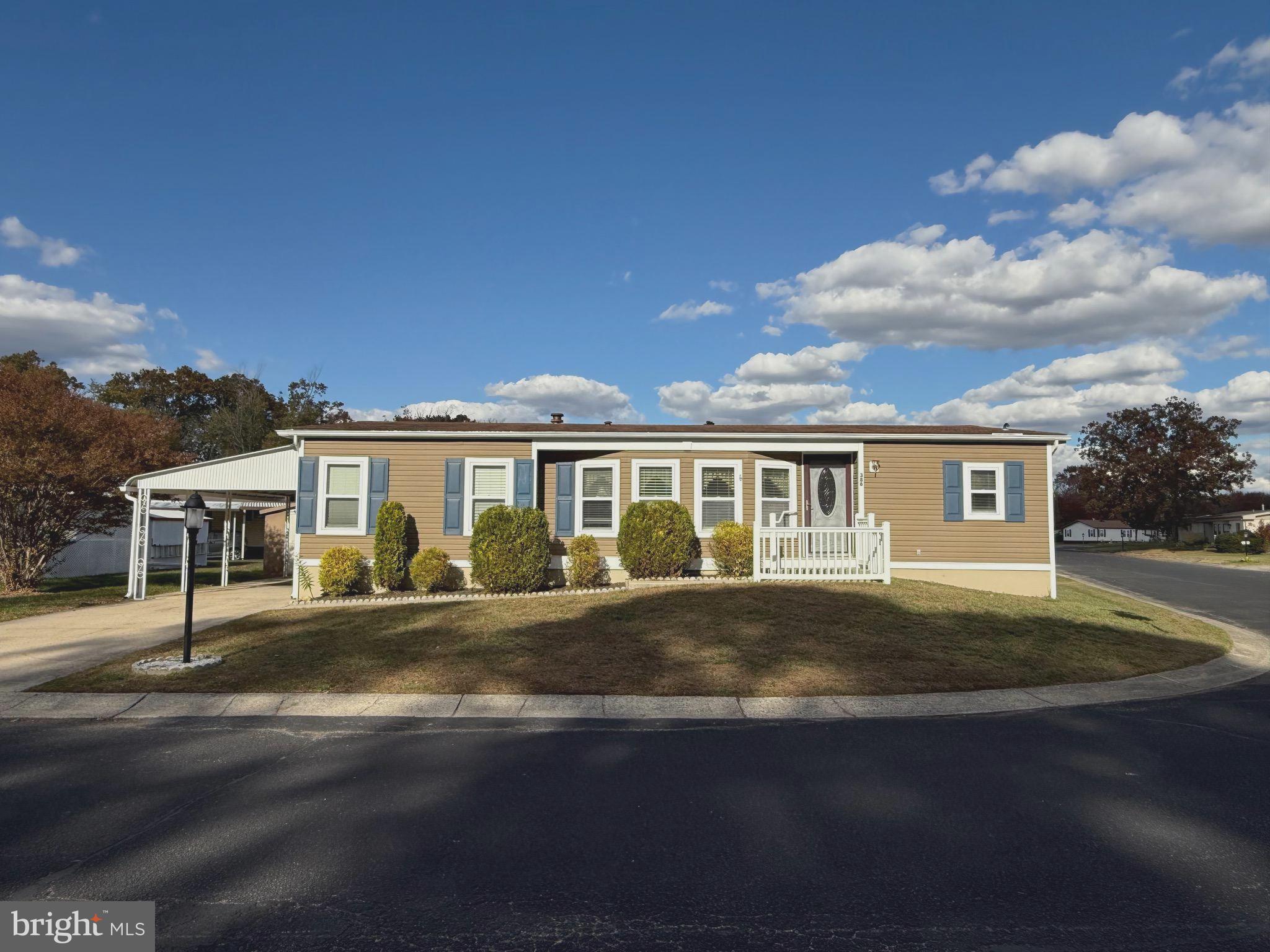 386 Indian Way Buena, NJ 08310 - Photo 2 of 53 a front view of a house with a garden