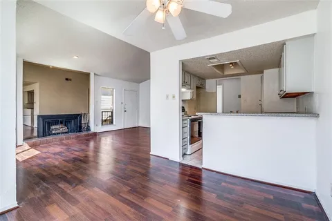 a view of a kitchen with a sink and a fireplace