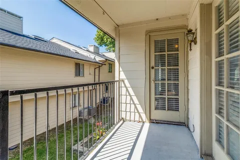 a view of balcony with wooden floor and fence