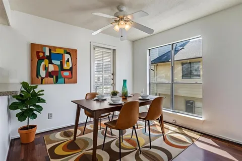 a dining room with furniture and window