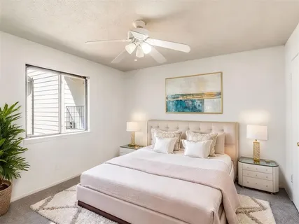 a bedroom with a bed and a window