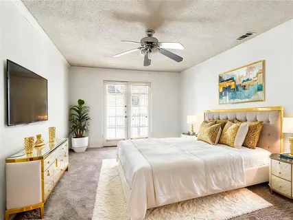 a bedroom with a bed and a flat screen tv