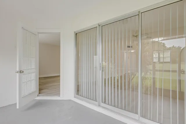 a view of a grassy field with trees