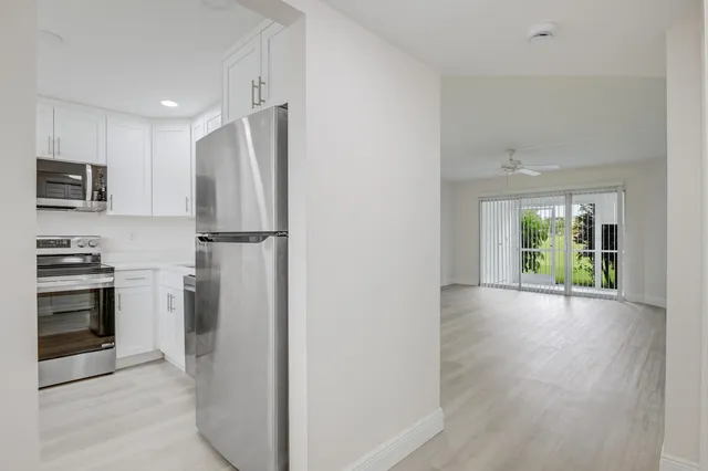a view of a kitchen with a stove microwave and refrigerator