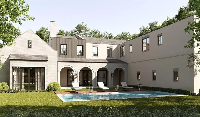 a large white building with a yard in front of it