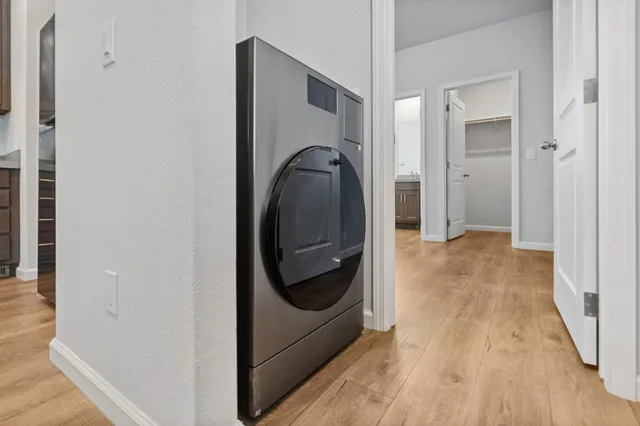 a view of an empty room with wooden floor