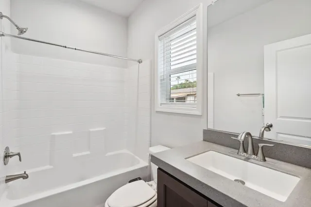 a view of a room with wooden floor and a window