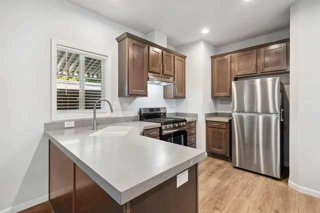 a kitchen with a stove sink and refrigerator