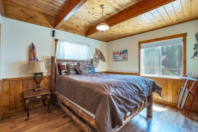 a bed sitting in a bedroom next to a window