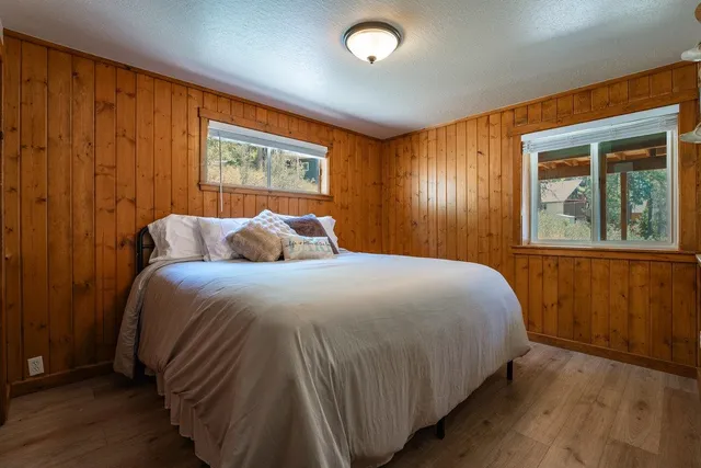 a bedroom with a bed and wooden floor