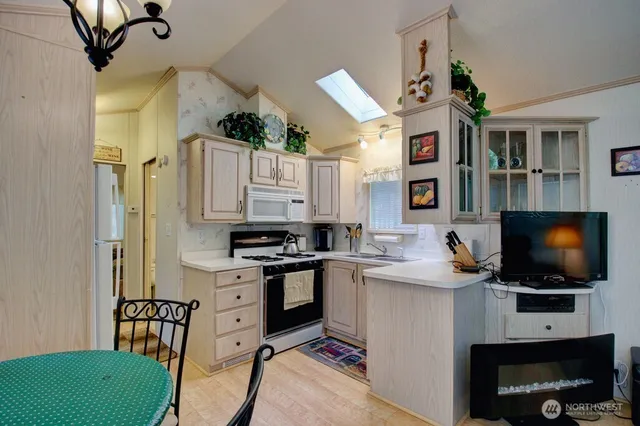 a kitchen with stainless steel appliances a stove a sink and a refrigerator