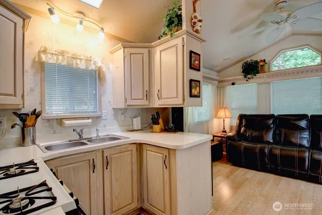 a kitchen with a sink stove and cabinets