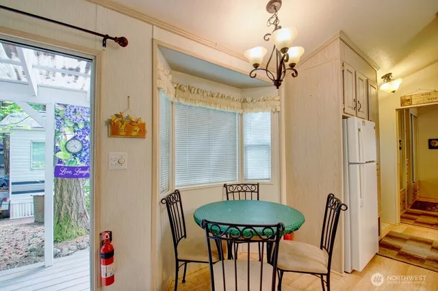 a view of a dining room with furniture and a chandelier