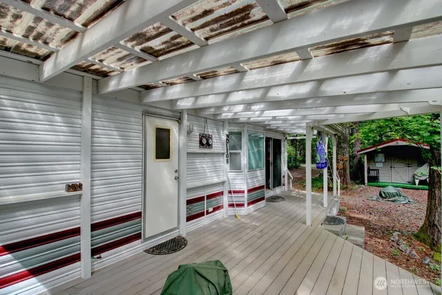 a view of a porch with furniture and a yard