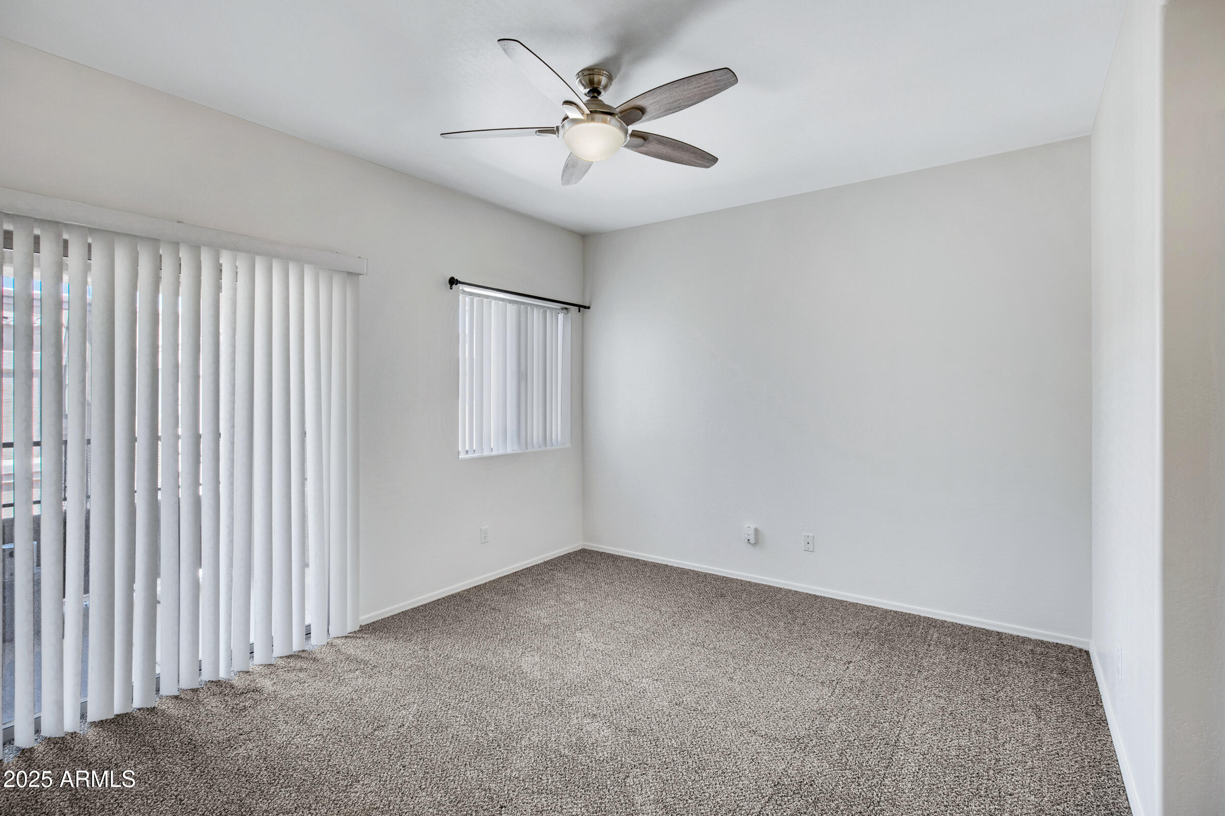 537 South Delaware Drive, Unit 224 Apache Junction, AZ 85120 - Photo 11 of 25 an empty room with windows and fan