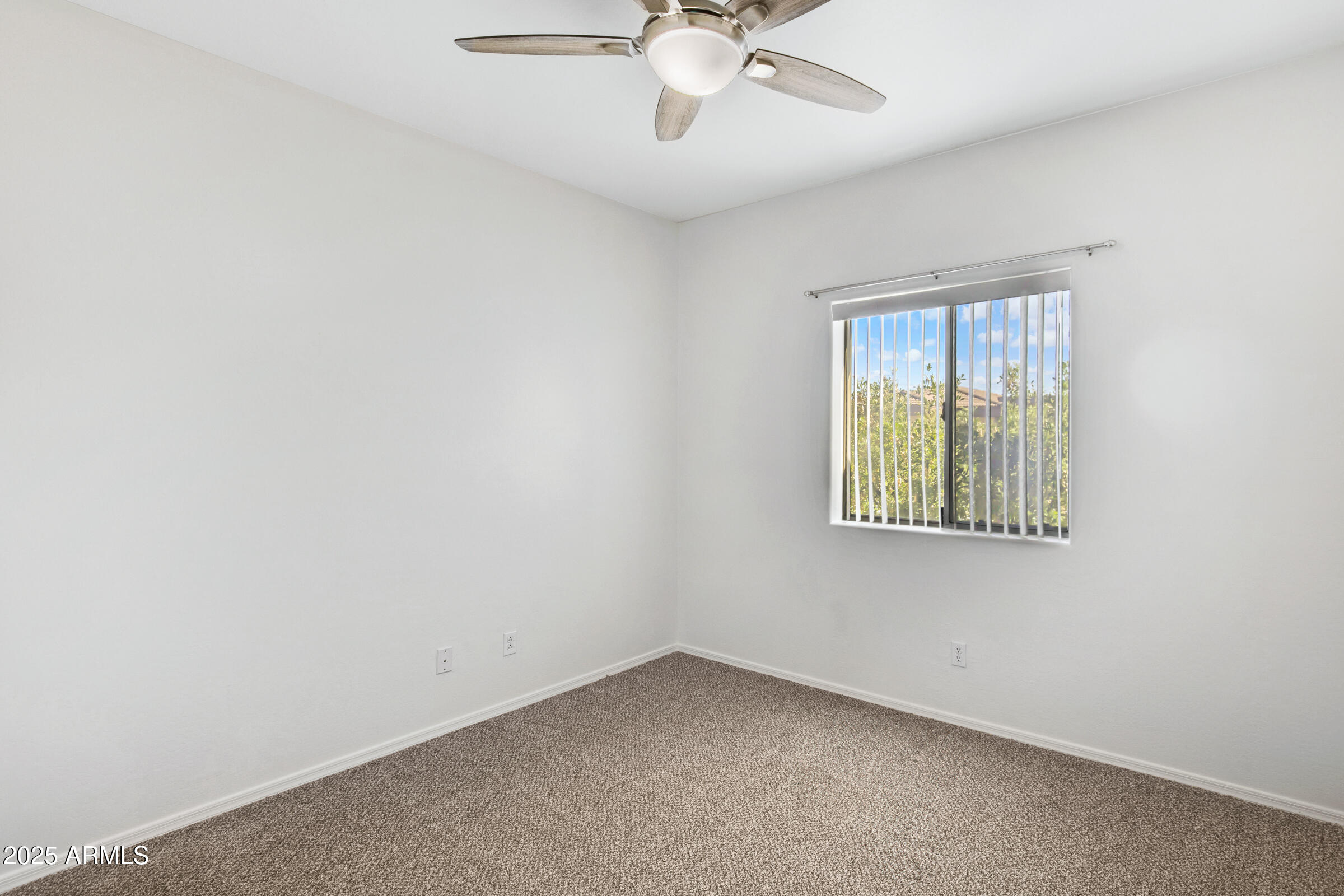 537 South Delaware Drive, Unit 224 Apache Junction, AZ 85120 - Photo 14 of 25 an empty room with a window and ceiling fan