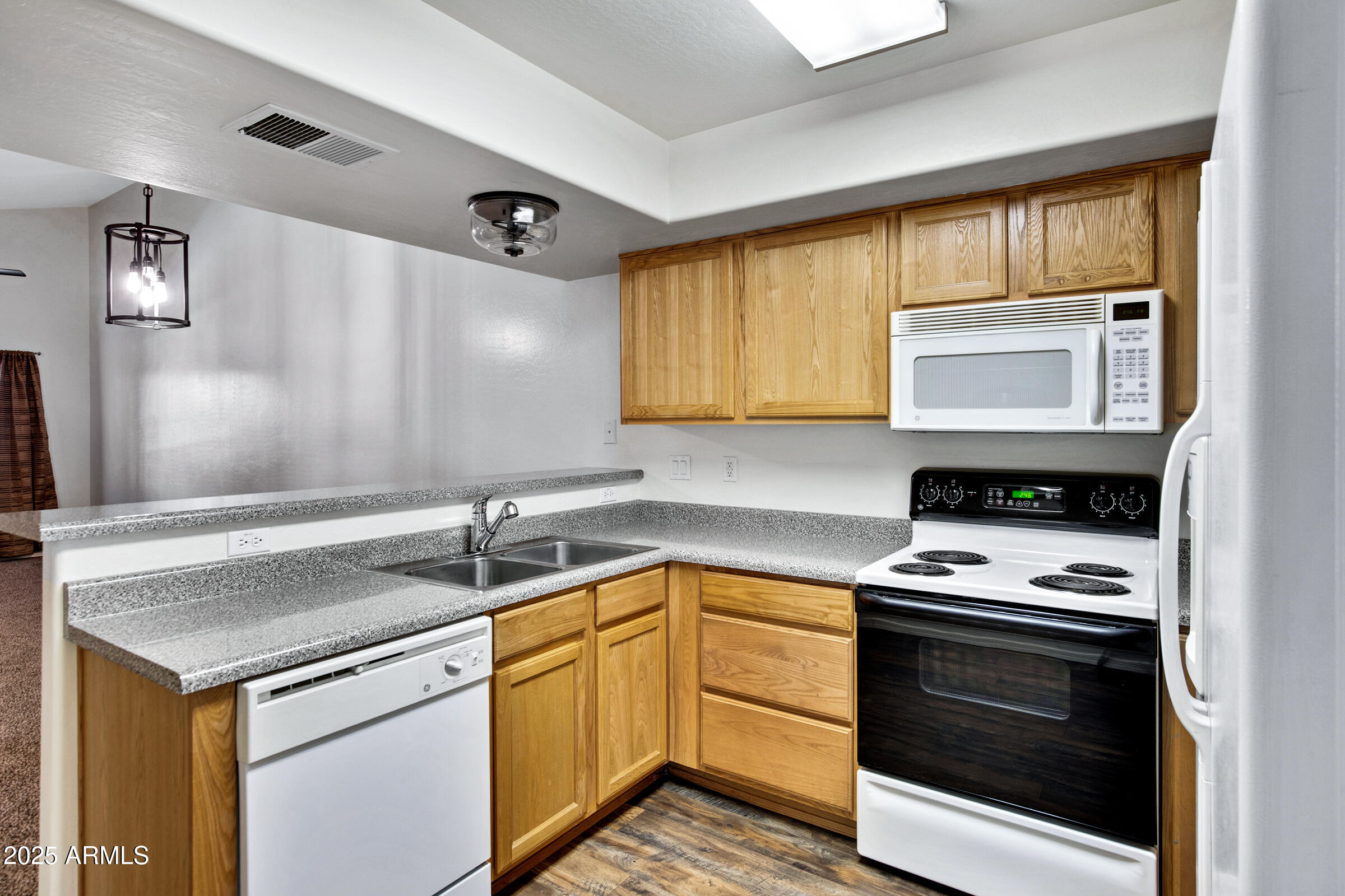 537 South Delaware Drive, Unit 224 Apache Junction, AZ 85120 - Photo 6 of 25 a kitchen with granite countertop a sink cabinets stainless steel appliances and a window