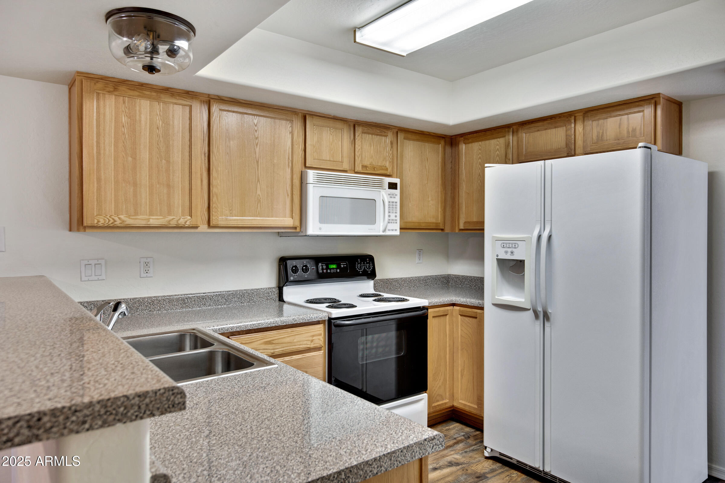 537 South Delaware Drive, Unit 224 Apache Junction, AZ 85120 - Photo 7 of 25 a kitchen with a refrigerator sink and cabinets