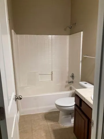 a bathroom with a toilet a sink and bathtub