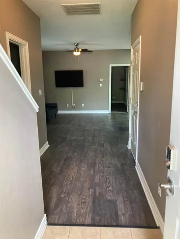 a view of hallway with wooden floor