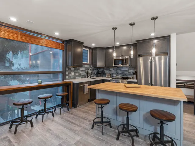 a kitchen with a table chairs refrigerator and microwave