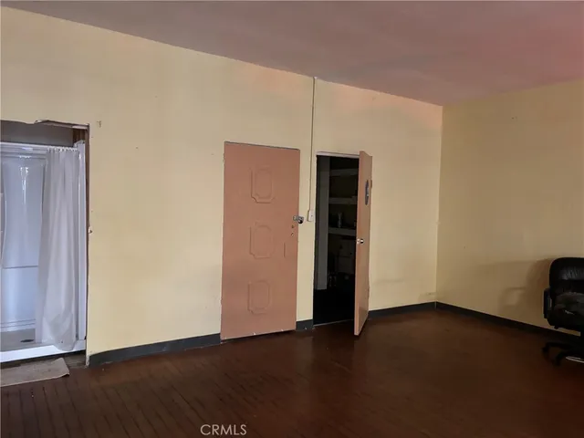 an empty room with wooden floor