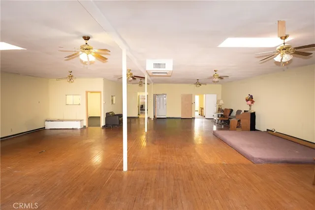 a view of a livingroom with a furniture chandelier fan and a table