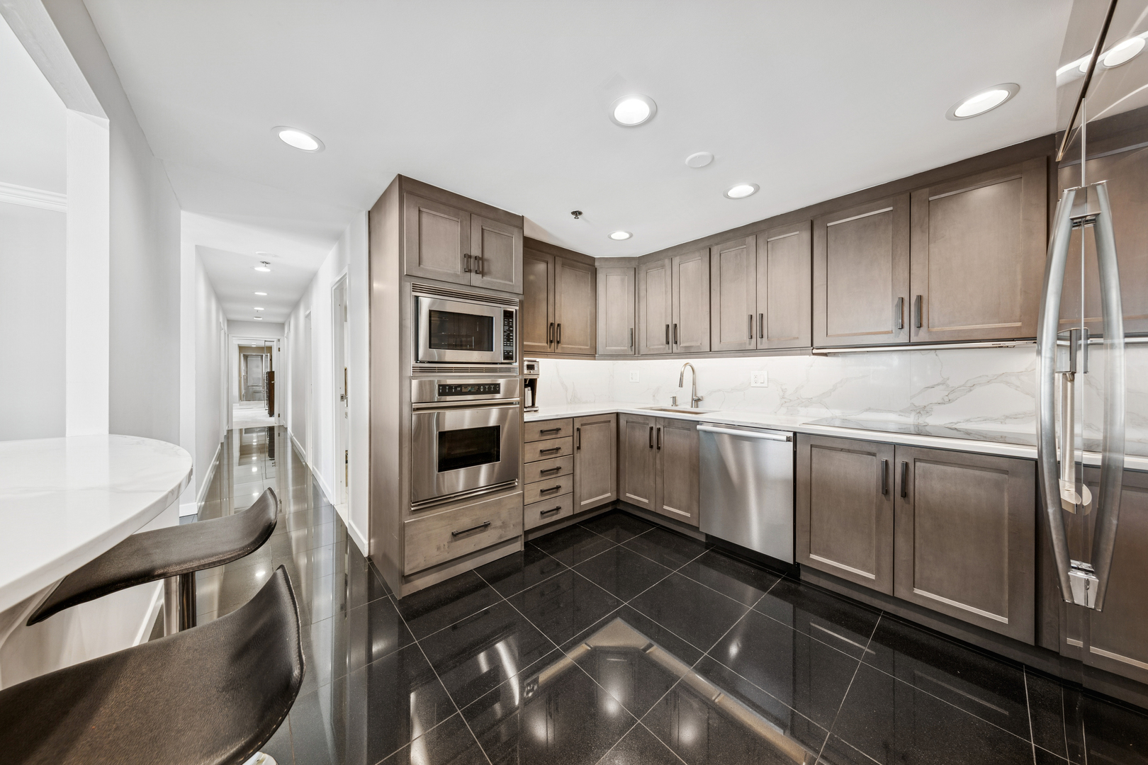 100 East Huron Street, Unit 2004 Chicago, IL 60611 - Photo 15 of 40 a kitchen with stainless steel appliances a stove a sink and a refrigerator
