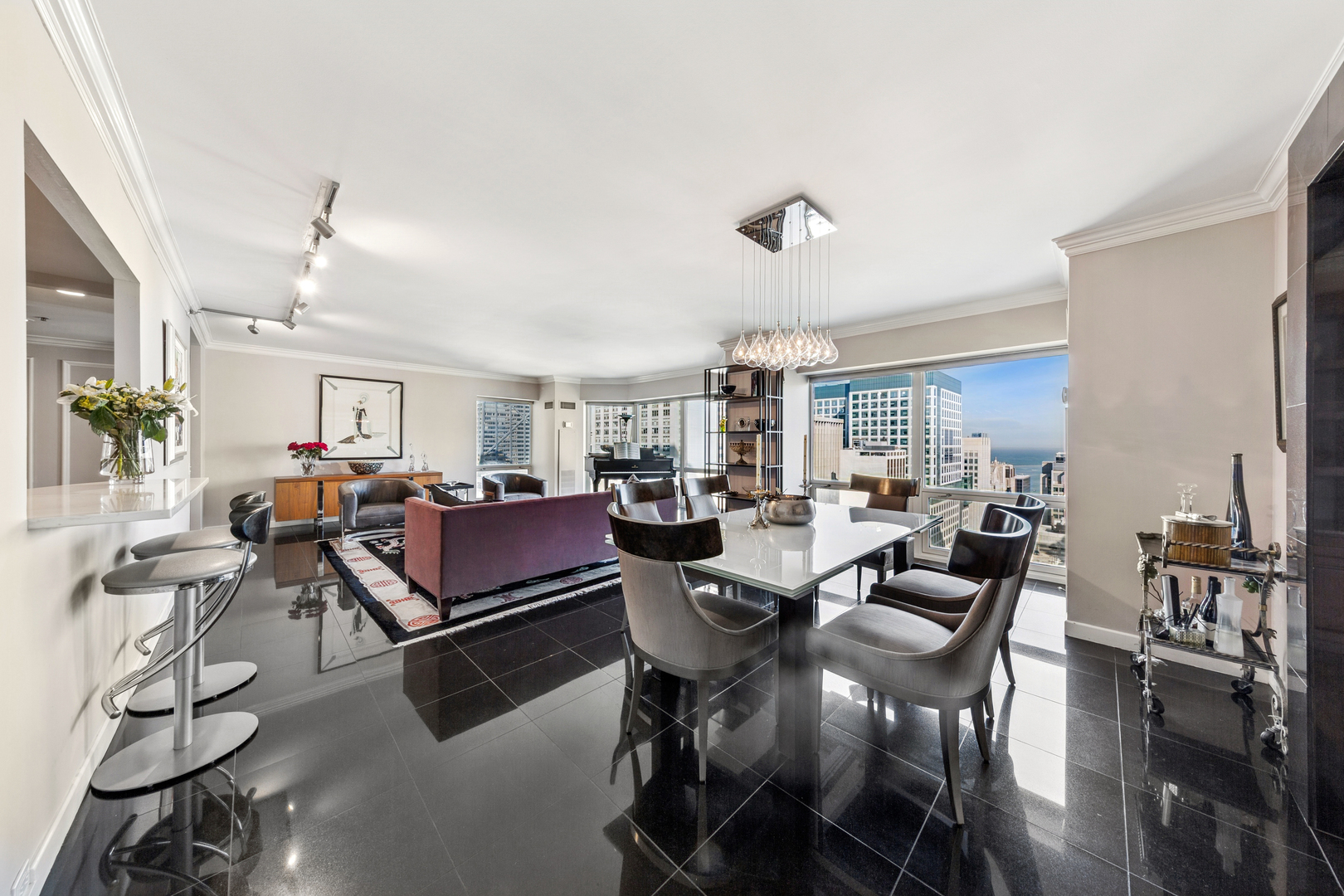 100 East Huron Street, Unit 2004 Chicago, IL 60611 - Photo 6 of 40 a living room with lots of furniture and a chandelier