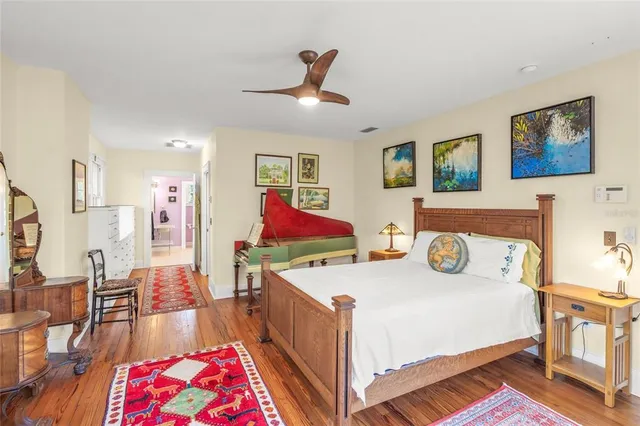 a bedroom with furniture and a wooden floor