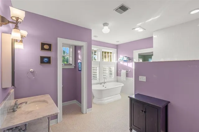 a spacious bathroom with a sink a toilet a mirror and vanity