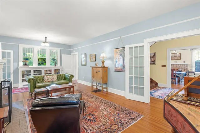 a living room with furniture rug and wooden floor