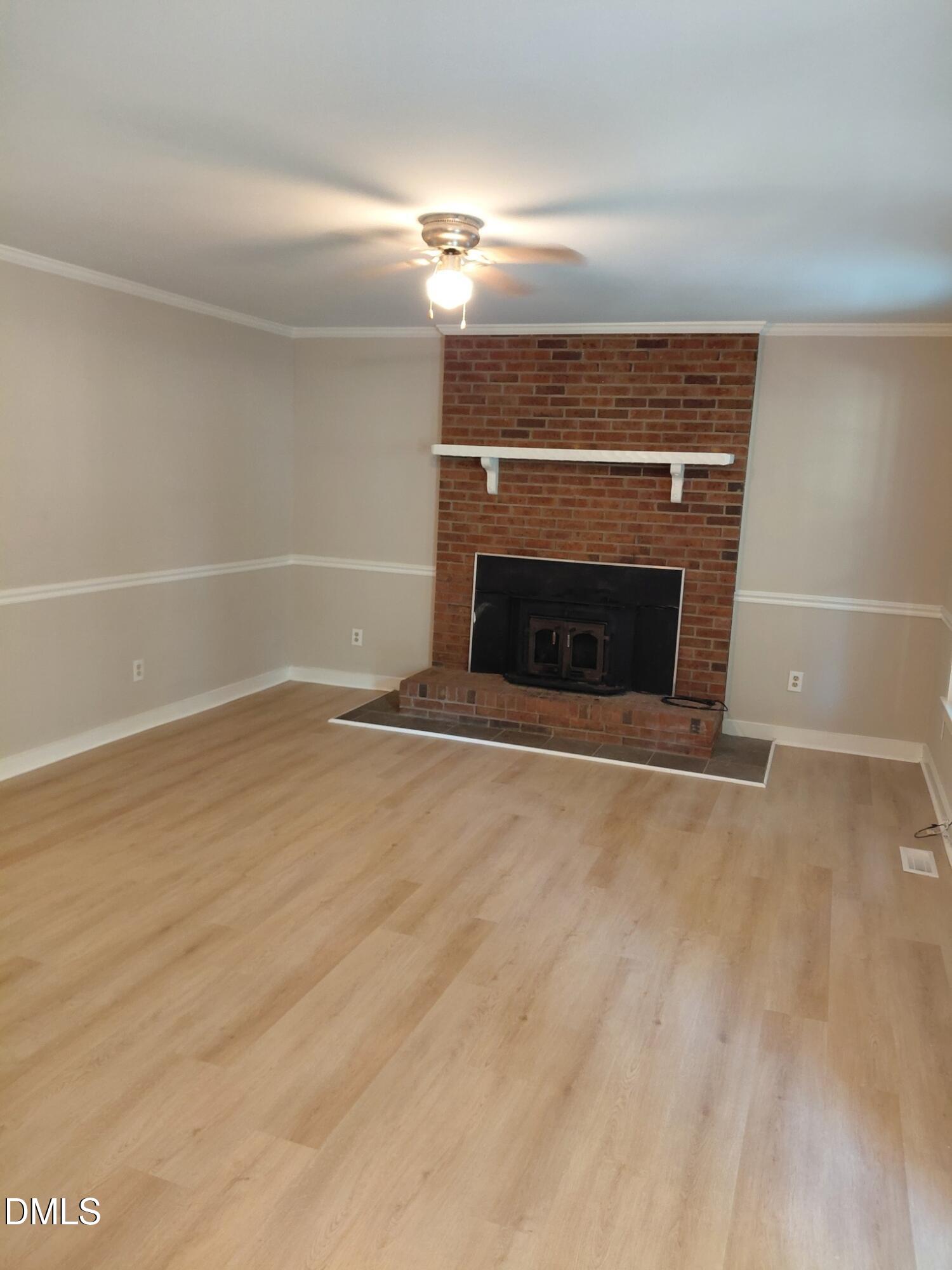 804 Olive Street Apex, NC 27502 - Photo 6 of 60 a view of empty room with a fireplace