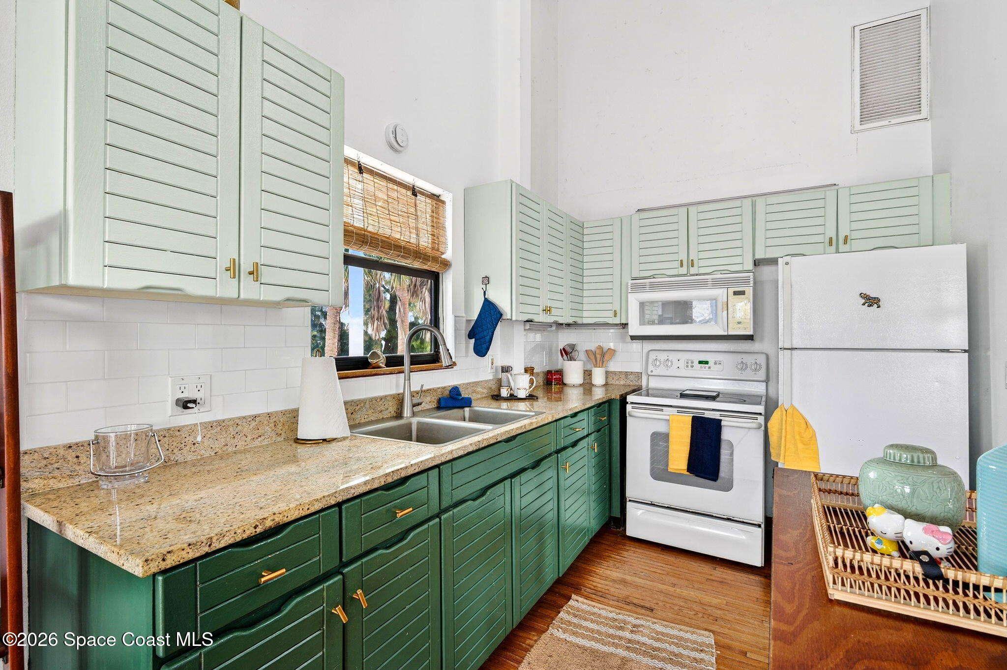 51 Vip Island, Unit B Grant, FL 32949 - Photo 14 of 49 a kitchen with cabinets and white appliances