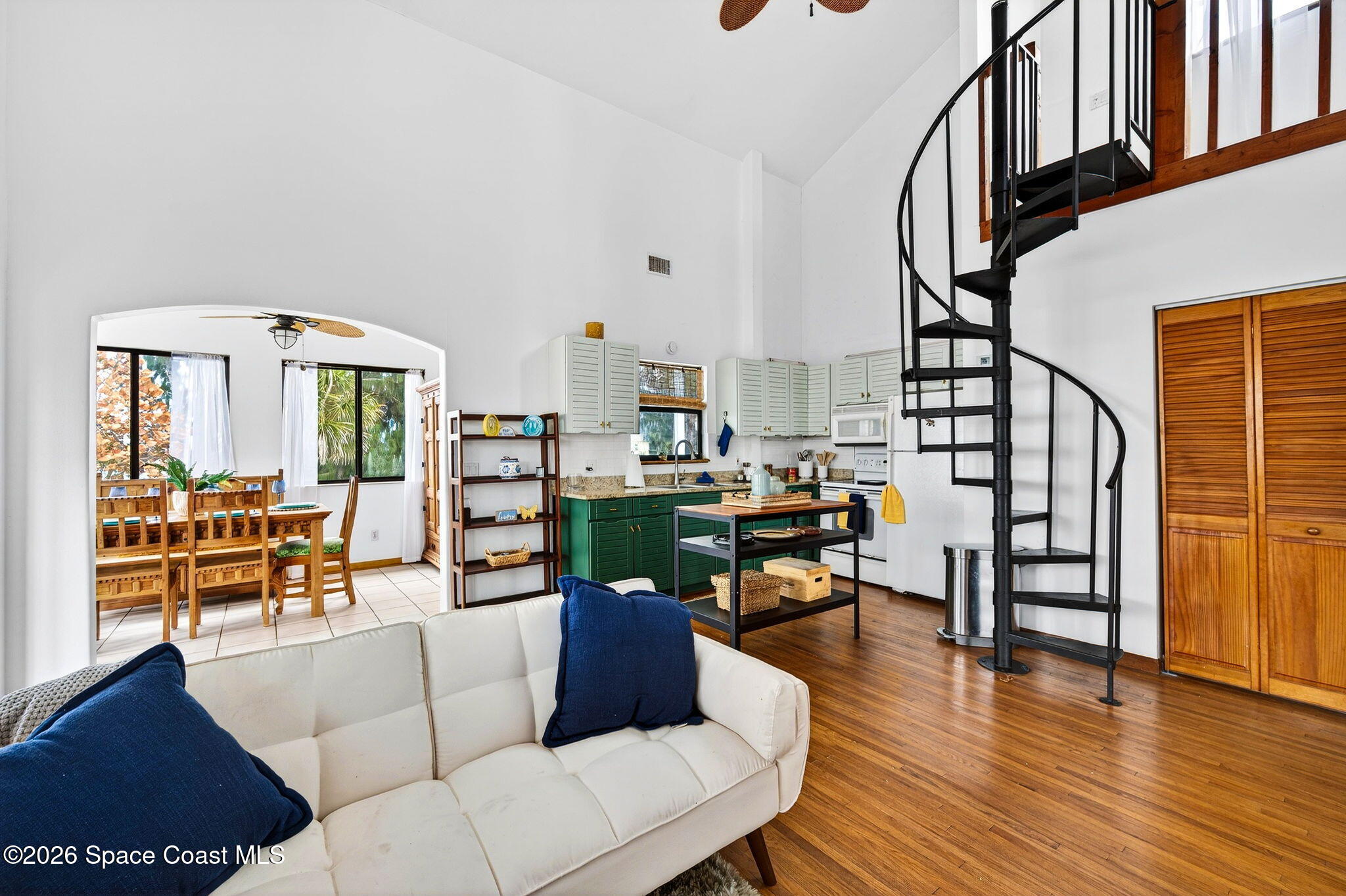 51 Vip Island, Unit B Grant, FL 32949 - Photo 17 of 49 a living room with furniture floor to ceiling window and wooden floor