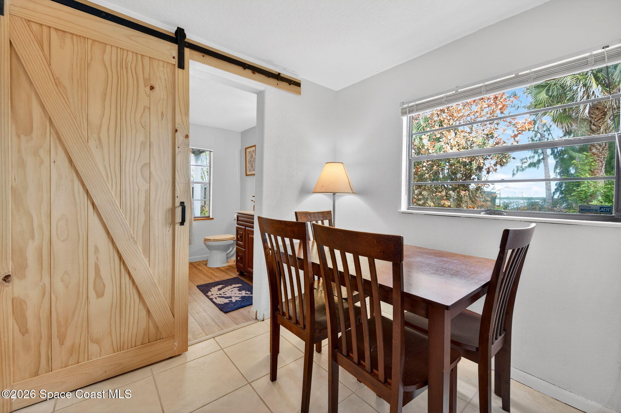 51 Vip Island, Unit B Grant, FL 32949 - Photo 29 of 49 a dining room with furniture and a window